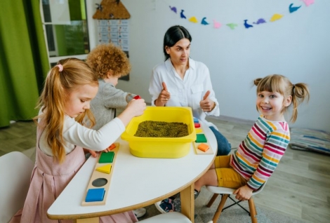 Preschool students playing with beans in kindergarten